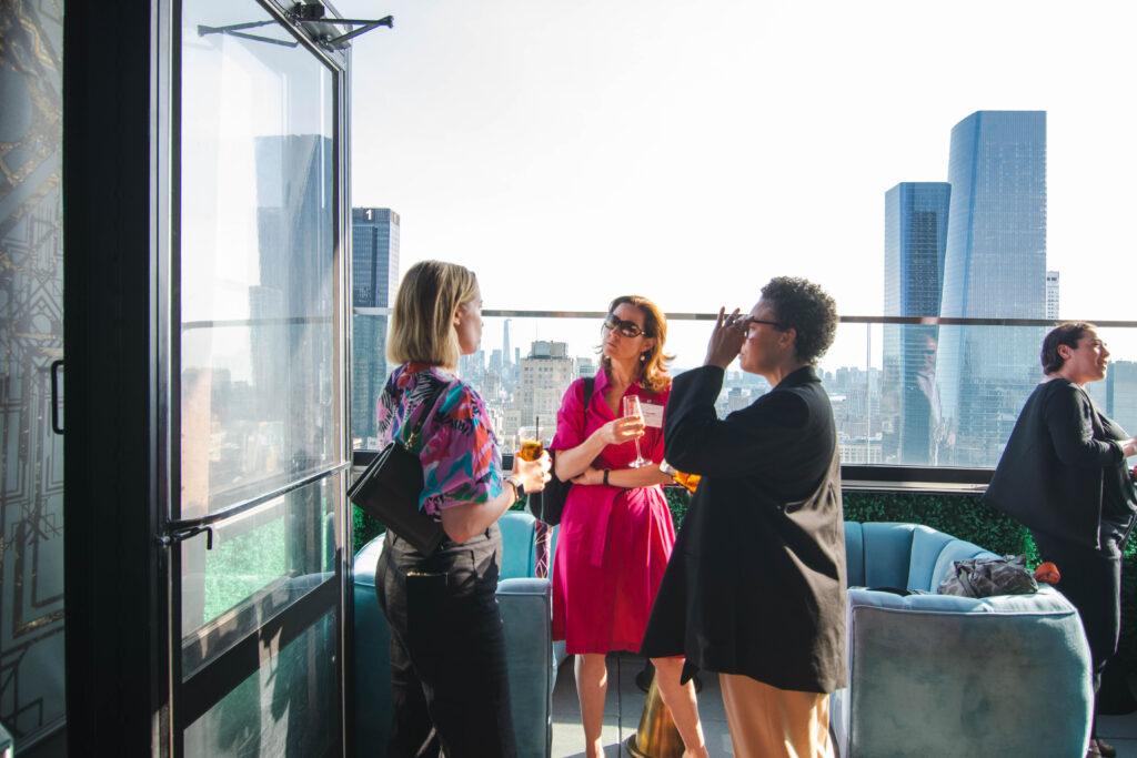 women discussing at a corporate event
