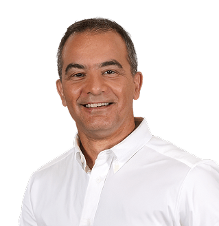 Portrait of a smiling man in a white collared shirt, facing the camera.